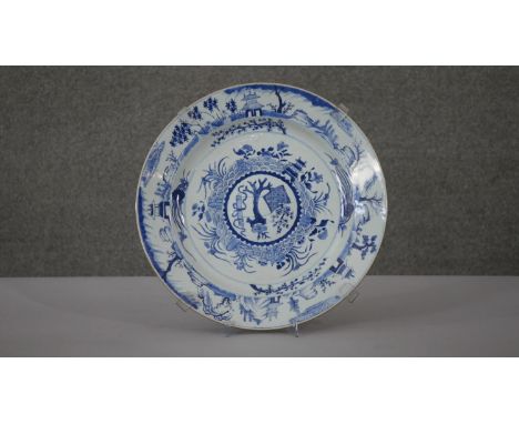 A large Kangxi blue and white hand painted porcelain charger. Decorated with temples and pagodas around the edge and central 