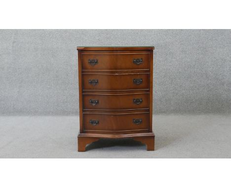 A small Georgian style flame mahogany serpentine fronted chest of drawers on shaped bracket feet. H.69 W.49 D.37 cm 