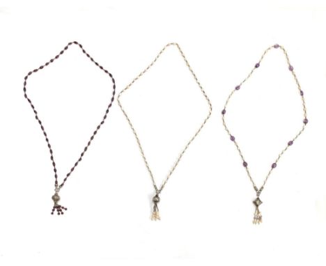 Three white metal bead sautoir style necklaces, one with cultured pearls and white metal beads and tassel; one with amethyst 