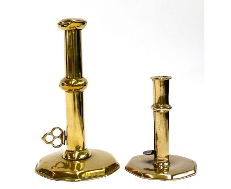 Two 18th century brass ejector candlestick holders (af), 13cmH and 21cmH 