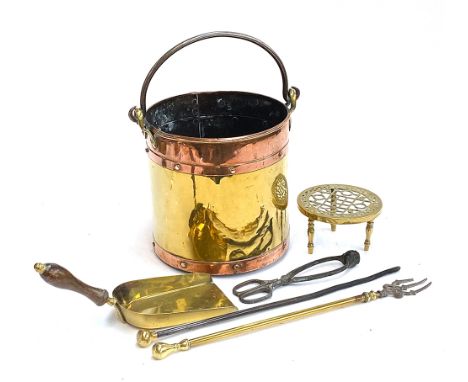 A 19th century riveted copper and brass coal bucket, with iron loop handle, 27cmH; together with a circular brass trivet; bra