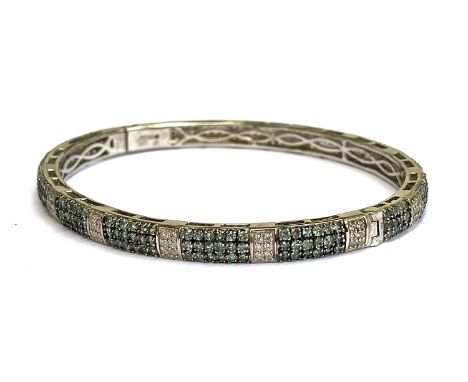 A sterling silver bangle with platinum vermeil set with alexandrite, 4.8cts, and natural white zircons, 0.99cts, 7.5cmW 