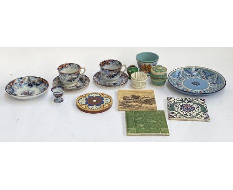 A small quantity of tiles to include a circular William Godwin encaustic terracotta tile, Mintons, Iznik style tile; 19th cen