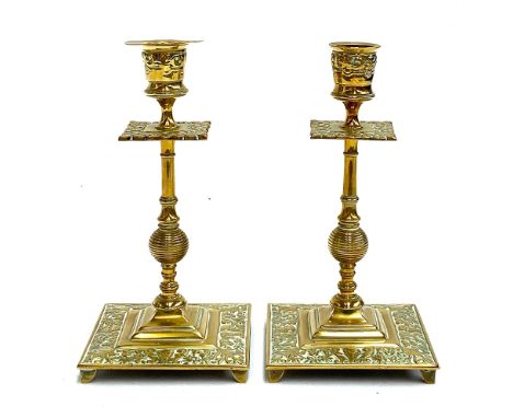 A pair of early 19th century brass candlestick holders, banded and knopped stems with Rococo style square foot, 19.5cmH 