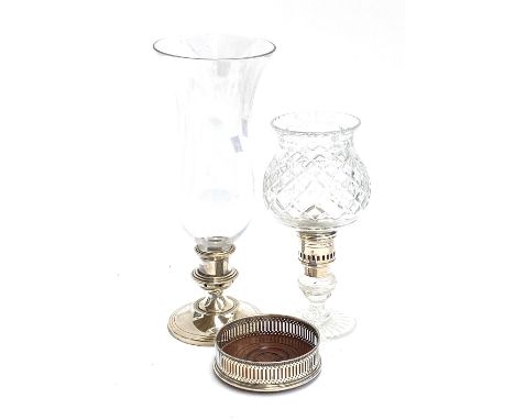 A cut glass and white metal candlestick holder, together with one other, 37cm and 27cm high; together with a white metal wine