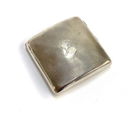 An engine turned silver cigarette case by A &amp; J Zimmerman Ltd, Birmingham 1925, with silver gilt interior, the central ca