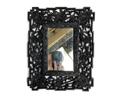 A small Chinese carved and pierced hardwood mirror, 30x23.5cm overall 