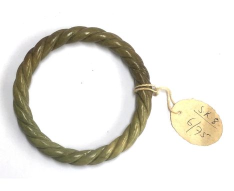 A vintage ropetwist carved hardstone bangle, internal diameter 7cm 