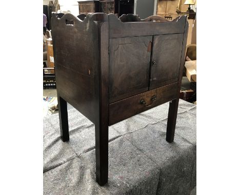 A George III mahogany tray top night commode, the gallery with cutout handles, over a pair of doors and converted drawer, on 