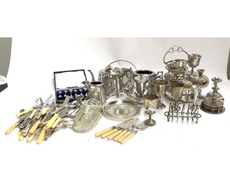 A quantity of silver plated items to include Martinoid teapot, swing handled basket, toast rack, cutlery, candlestick holders