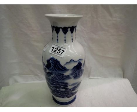Chinese blue and white vase decorated with a mountain landscape. H: 27cm. UK P&amp;P Group 2 (£20+VAT for the first lot and £