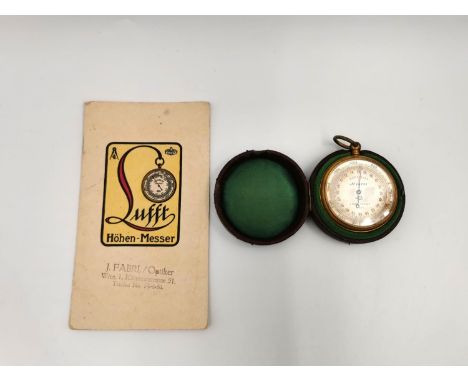 An early 20th century brass cased compensated pocket barometer with its original baize lined leather case and booklet by Luff