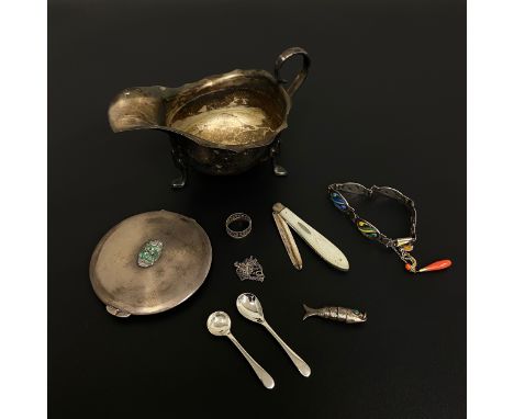 A collection of hallmarked silver to include a George III style footed gravy boat marked Harrods London, a compact mirror ins