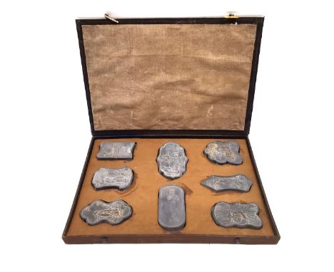 A Chinese calligraphy stone ink block set circa 1900, intricately carved in relief with gilt embellishments, with fitted box.