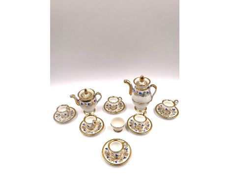 A miniature porcelain tea set with six cups and saucers, a teapot, and a coffee pot. Probably Staffordshire, from the Mona Sa