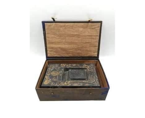 A Chinese calligraphy stone ink block circa 1900, intricately carved in relief with hand painted gilt embellishments, with fi