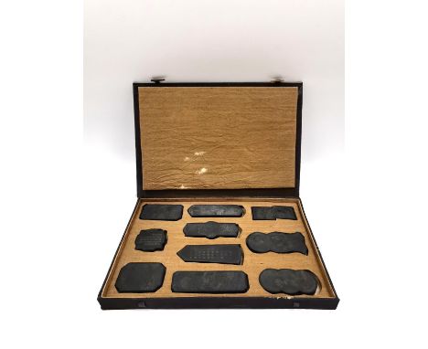 A Chinese calligraphy stone ink block set circa 1900, intricately carved in relief with gilt embellishments, with fitted box.