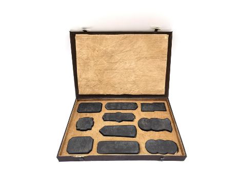 A Chinese calligraphy stone ink block set circa 1900, intricately carved in relief and hand painted with gilt embellishments,