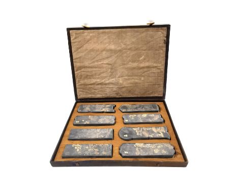 A Chinese calligraphy stone ink block set circa 1900, intricately carved in relief and hand painted with gilt embellishments,