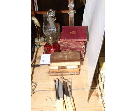 Old volumes, Ancient Relics and Shakespeare, two glass decanters, ruby oil lamp and knives