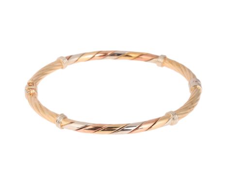A 9ct three-colour gold hinged bangle, hallmarks 1996, band width 4.1mm, internal circumference 18cm, 9.6g . Condition Report