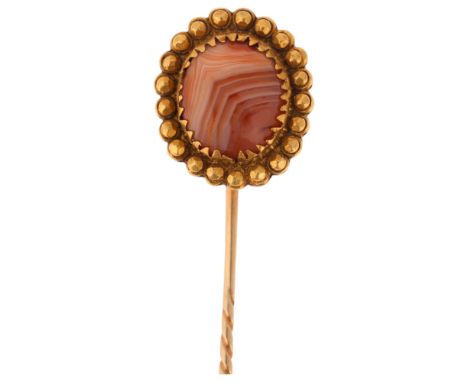 An Antique Victorian 14ct gold banded agate stickpin, set with round cabochon agate within beaded surround, unmarked mount te