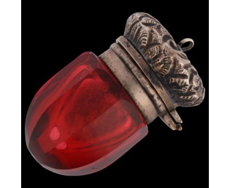 A Victorian miniature novelty silver-mounted ruby glass acorn vinaigrette, faceted form with floral relief embossed cap and i