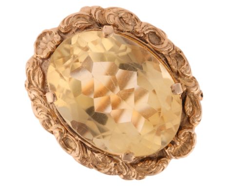 A large 9ct gold citrine dress ring, maker LGH, set with oval mixed-cut citrine within relief foliate surround, setting heigh
