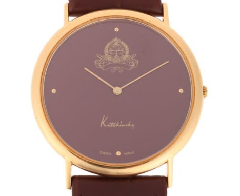 KUTCHINSKY - an 18ct gold 'Saudi Arabia Emblem' quartz wristwatch, maroon dial with gilt quarterly dot hour markers, pencil h