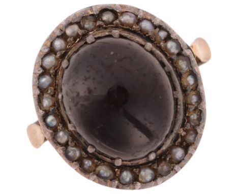 A Victorian garnet and pearl cluster mourning ring, circa 1880, centrally cut-down collet set with foil-back oval cabochon ga
