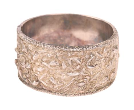 An Antique Chinese silver 'Sealife' hinged bangle, signed with artisan mark, relief decoration depicting fish seashells and c
