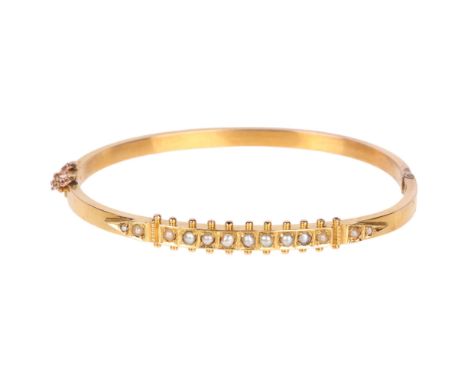 An Antique Victorian Etruscan Revival 15ct gold split pearl hinged bangle, with beaded decoration, band width 5.6mm, internal
