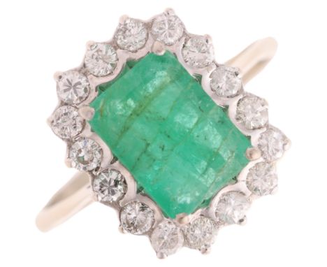 An 18ct white gold emerald and diamond cluster ring, set with octagonal step-cut emerald and modern round brilliant-cut diamo