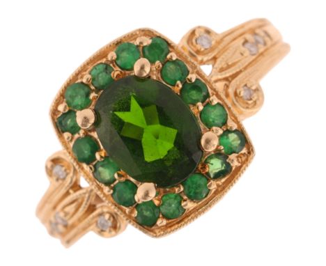 A 14ct gold green garnet and diamond cluster ring, setting height 12.8mm, size O, 4.1g . Condition Report:No damage or repair