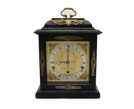 An ebonised caddy top mantel clock,20th century, retailed by Elliot, London, the brass dial with foliate engraving and silver