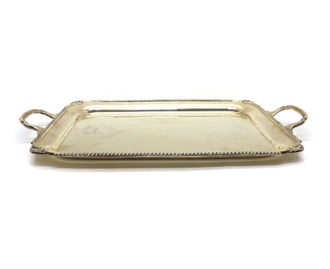 A silver twin handled tray, by Viner’s Ltd, London 1934, with a shaped border, 55cm wide 64oztScratches, wear and rubbing thr