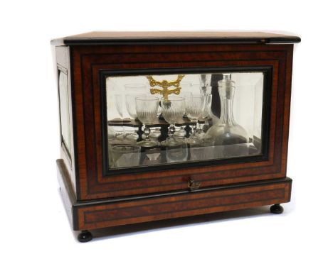 A 19th century French liqueur cabinet,the case inlaid with tulipwood and amboyna and with five bevelled glass panels and lift