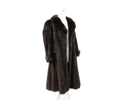 A dark brown full length mink fur coat,by Geister Furs Ltd, London, side slip pockets, with a belt, three-button closure to t