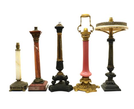 A group of five column table lamps,comprising a neo-classical cast metal and gilt brass table lamp, on three lion paw feet an