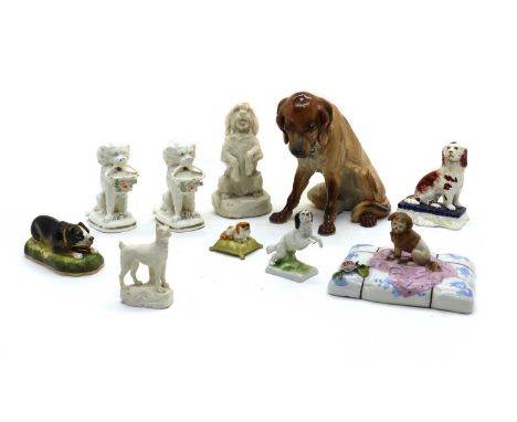 A collection of pottery and porcelain figures of dogs,19th and 20th century, to include a Royal Worcester example17cm high (1