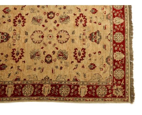 A Zeigler carpet,with a pale field to a red border,198 x 148cmStains and losses to the tassels.