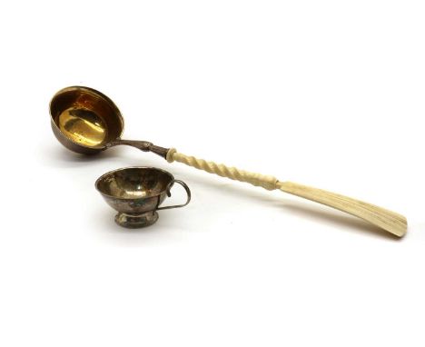 A Continental white metal Toddy Ladle,late 19th century, with a gilt bowl and carved bone handle,38cm longtogether with a Fin