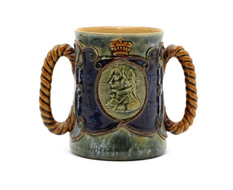 A Royal Doulton stoneware commemorative twin handled cup,late 19th century, decorated with a profile portrait of Lord Nelson,