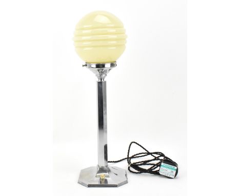 An Art Deco table lamp, in chrome with an opaque beige glass globular shade, on faceted stem with spreading base, 46 cm high,