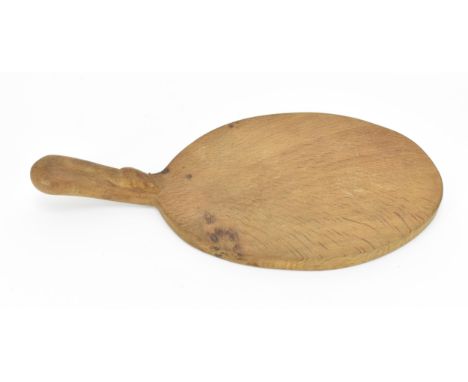 Robert Thompson of Kilburn (1876-1955) Mouseman- an oval oak cheese board, with carved signature mouse to handle, 37.5 cm lon