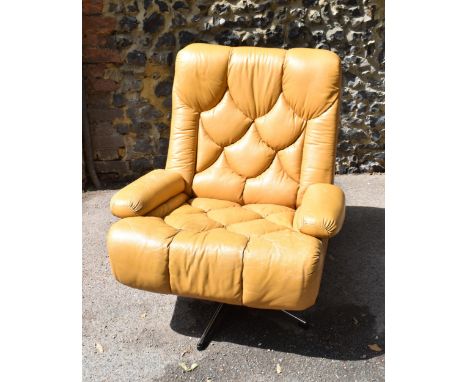 A 1970s Danish Tetrad Nucleus swivel armchair, in yellow/light tan leather, thick padded seat and armrests, on a chromium pla