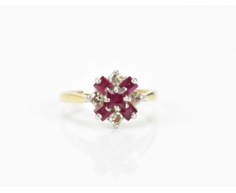 An 18ct yellow gold, platinum, diamond and ruby floral cluster ring, set with five step cut rubies and four round brilliant c