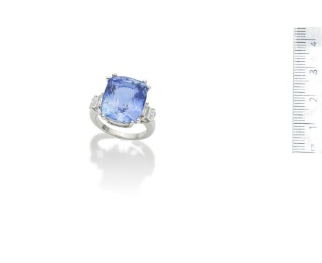 A sapphire and diamond ringThe cushion-shaped sapphire, weighing 18.50 carats, between step-cut diamond shoulders, ring size 