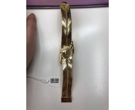 A gold and diamond watch/bracelet, by Kutchinsky circa 1970The hinged ropetwist cover set with a scroll of brilliant-cut diam