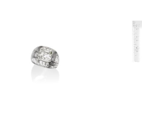 A diamond and tourmalinated rock crystal dress ringThe step-cut diamond, weighing 9.12 carats, inlaid within a bombé mount fo